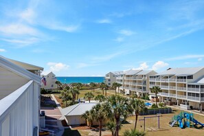 A resort with multiple-story buildings, a playground, and a view of the ocean. - Sea Cliff I-51 Coastal Splendor (Port St. Joe)