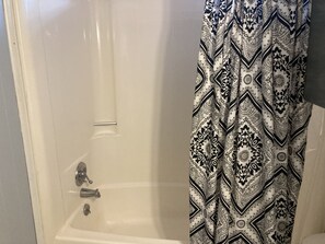 Combined shower/tub, hair dryer, towels, soap - Comfy home, 3rd row, step from the beach! (Oak Island)
