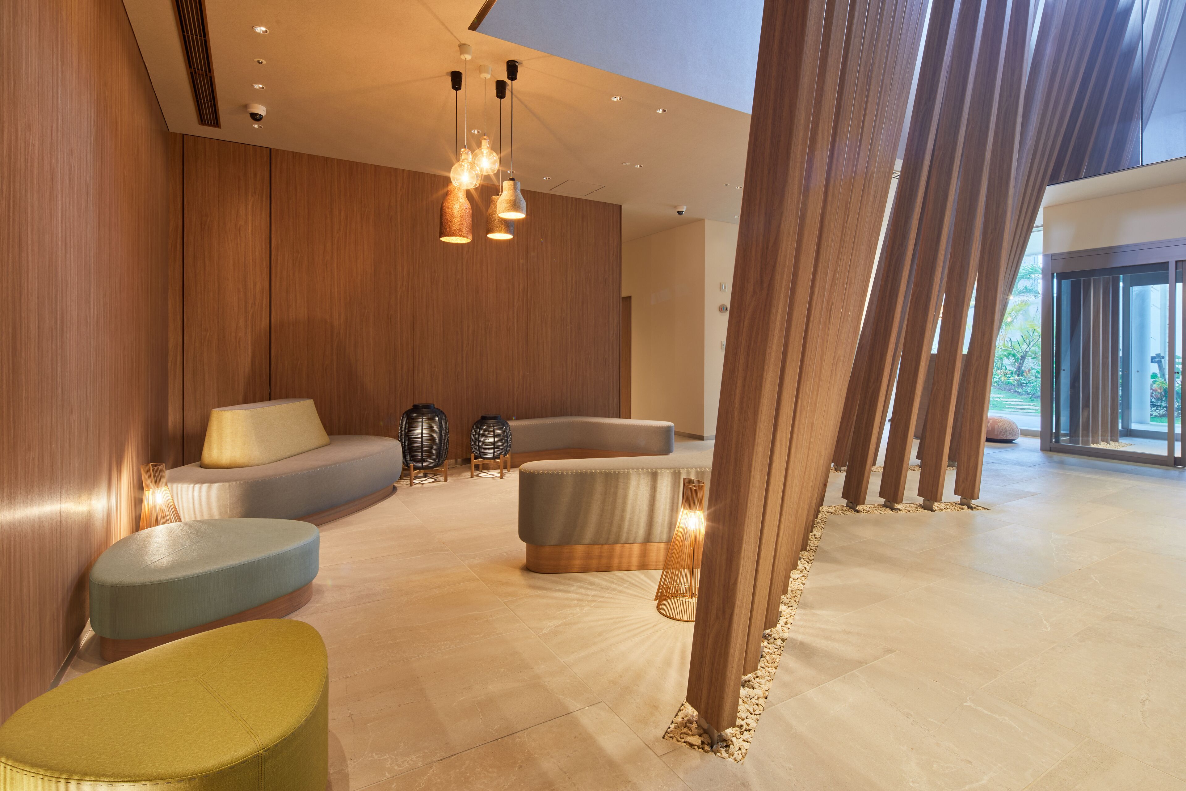 A modern interior with a seating area, wooden walls, and a large window.