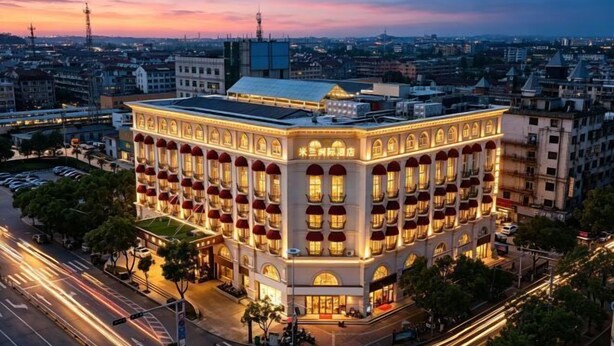 A multi-story building with a classic architectural style, featuring a symmetrical facade with evenly spaced windows and a central entrance.