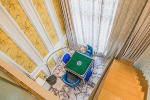 A room with a green pool table, blue chairs, and a marble floor. - International Milan (Deqing)