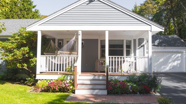 A single-story house with a covered porch, a hammock, and a brick pathway leading to the front door. - Relax by Oak Bluffs Harbor, enjoy your 3-bedroom East Chip retreat (Oak Bluffs)