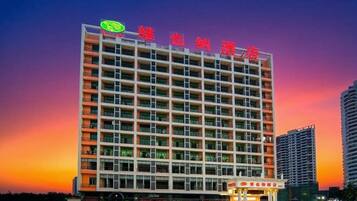 A multi-story hotel with a prominent sign at the top.