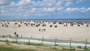 A beach with numerous tents and people.
