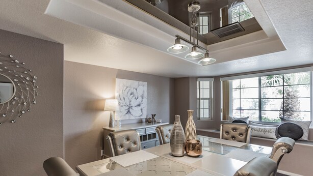 A dining area with a large table, cushioned chairs, a chandelier, and artwork on the walls. - Private Vegas Executive Home 15 Min To Strip Quiet Neighborhood (Las Vegas)