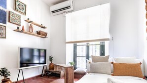 A modern hotel room with a large bed, a flat-screen TV, a wooden desk, and decorative wall art. - Enjoy the magic of Triana Sevilla, Calle Castilla (Sevilla)