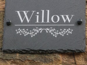 A slate sign with the word "Willow" and decorative floral patterns. - Willow Cottage (Sheffield)