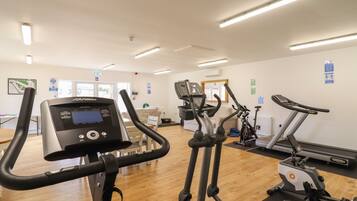 A gym with various exercise machines, including treadmills and elliptical trainers.