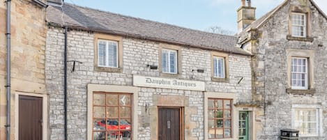 A stone building with a sign for 'Dawphin Antiques'.