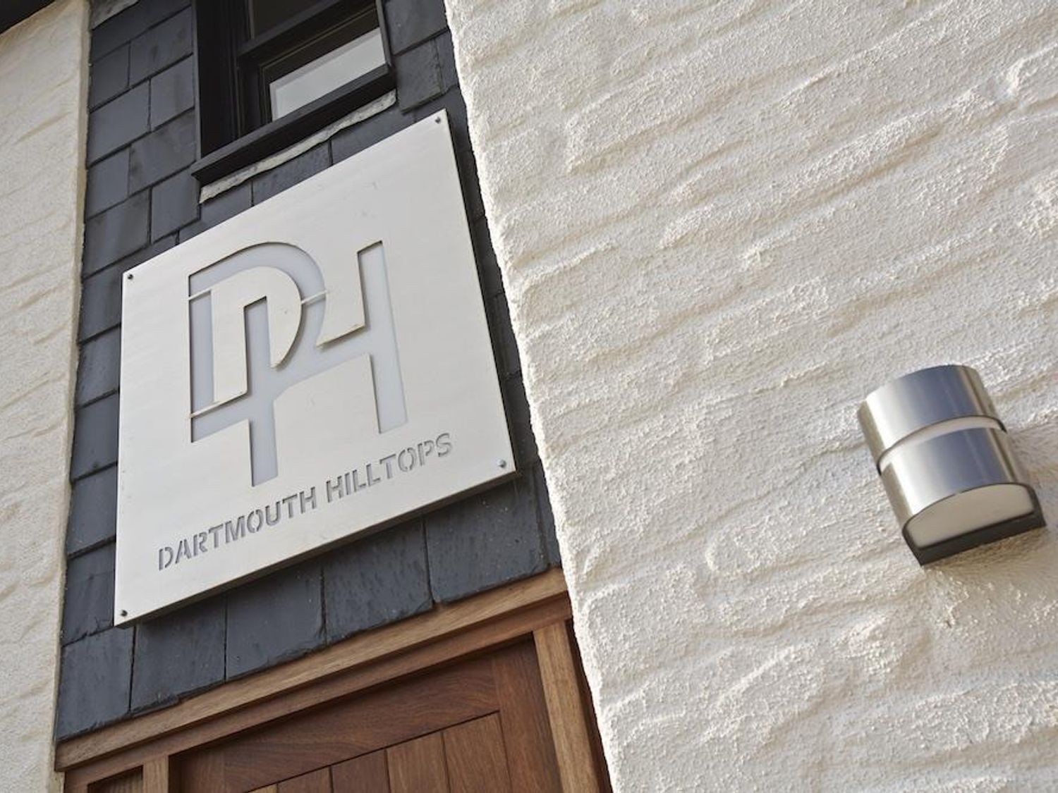 A sign for Dartmouth Hilltops with a modern design.