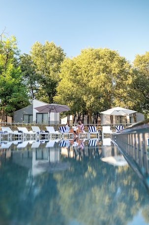 Seasonal outdoor pool, open 9:00 AM to 7:30 PM, pool umbrellas. FoRest Village Resort