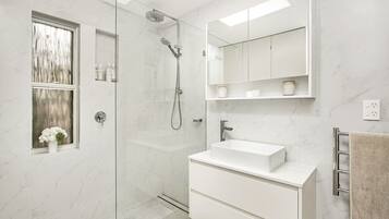 Shower, hair dryer, towels, toilet paper