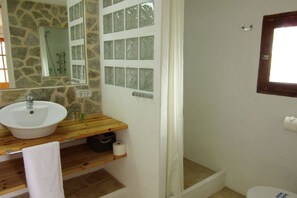 Bathroom features a sink, shower, and toilet.