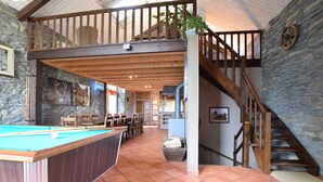 A spacious indoor area with a pool table, wooden ceiling beams, stone walls, and a staircase leading to an upper level. - Renovated Mill in Bastogne near Waterfall (Bastogne)