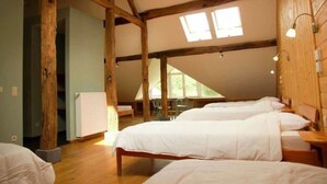 A room with wooden beams, a sloped ceiling, and two beds with white bedding. - Holiday Home in Stoumont near Spa Resort (Stoumont)