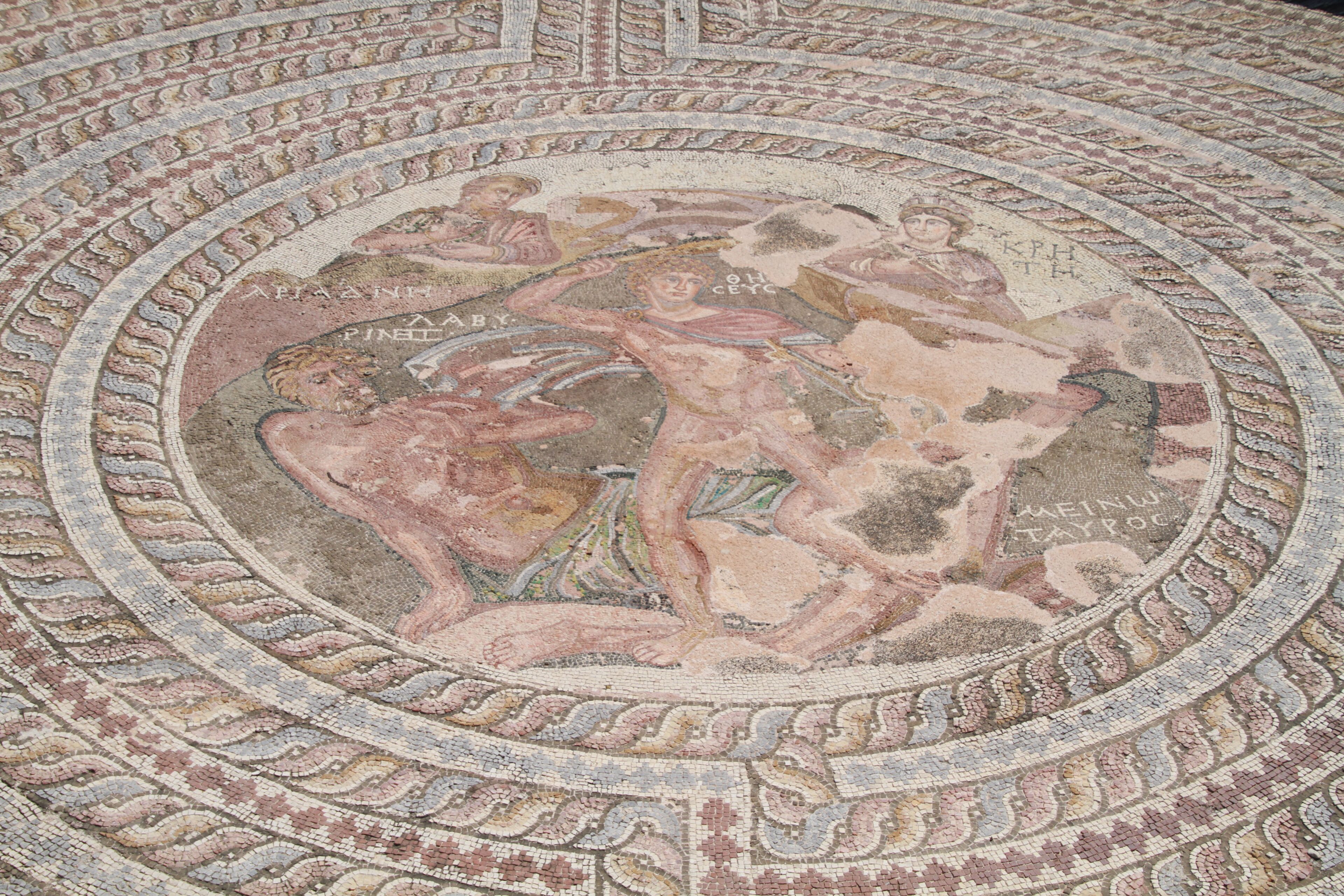 A detailed mosaic with intricate patterns and figures, likely part of a historical or cultural site.