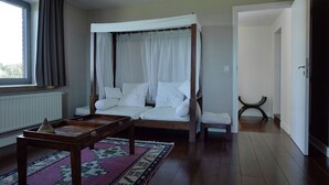 A bedroom with a four-poster bed, a wooden nightstand, and a window with curtains. - Lavish Castle in Thimister with Turkish Steambath, Sauna (Thimister-Clermont)