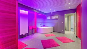 A modern bathroom with a freestanding bathtub, pink towels, and a vanity with a mirror. - Holiday Home in Malmedy with Sauna & Bubble Bath (Malmedy)