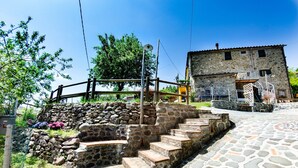 Una escalera de piedra que conduce a un edificio de piedra con suelo de baldosas.