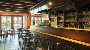 A bar area with stools, a bar counter, and a sign that reads "FINE WINE Served."