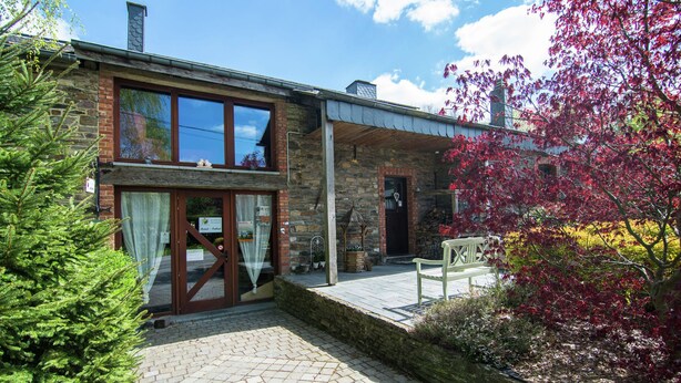 A two-story stone building with a covered porch, a brick chimney, and a stone fireplace. - Quaint Apartment in Sensenruth with Terrace (Sensenruth)