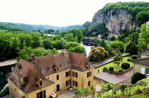 Situated on a lush hillside, this historic building offers a serene view of the river flowing through the valley.