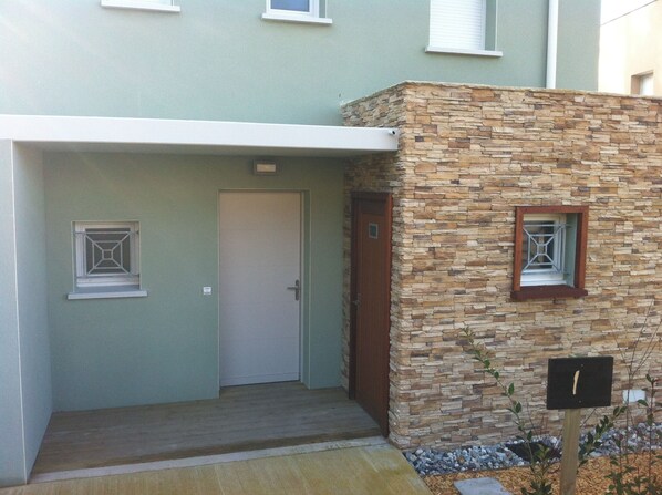 A building with a stone facade, a door, and a small window.
