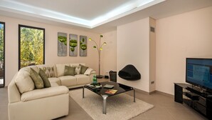 A modern living room with a sofa, coffee table, and artwork on the wall.