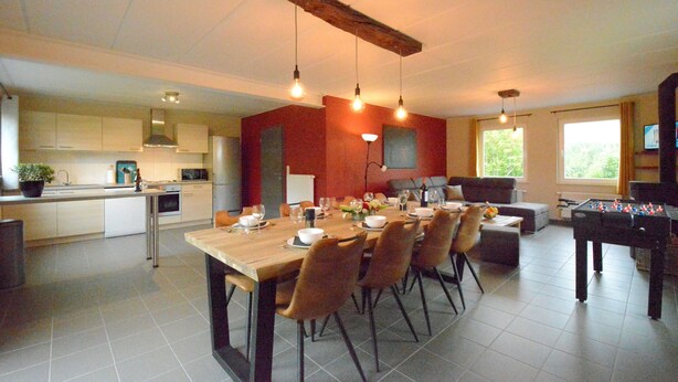 A modern kitchen with a dining area, a foosball table, and a television. - Villa in Berismenil near Forest (Berismenil (La Roche-en-Ardenne) Ardennes)