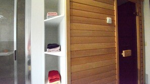 A room with a wooden door, a white shelf with folded clothes, and a white wall. - Villa in Berismenil near Forest (Berismenil (La Roche-en-Ardenne) Ardennes)