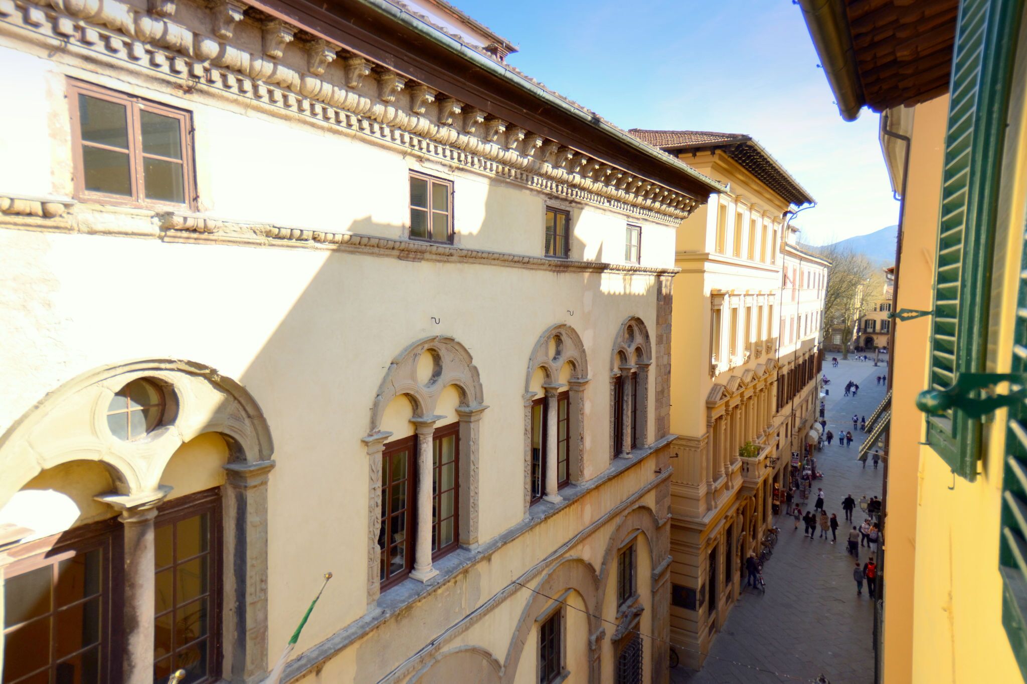 A historic building with arched windows and a central courtyard.