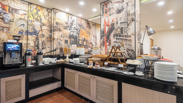 Un bufé de desayuno con gran variedad de alimentos y una estación de café.