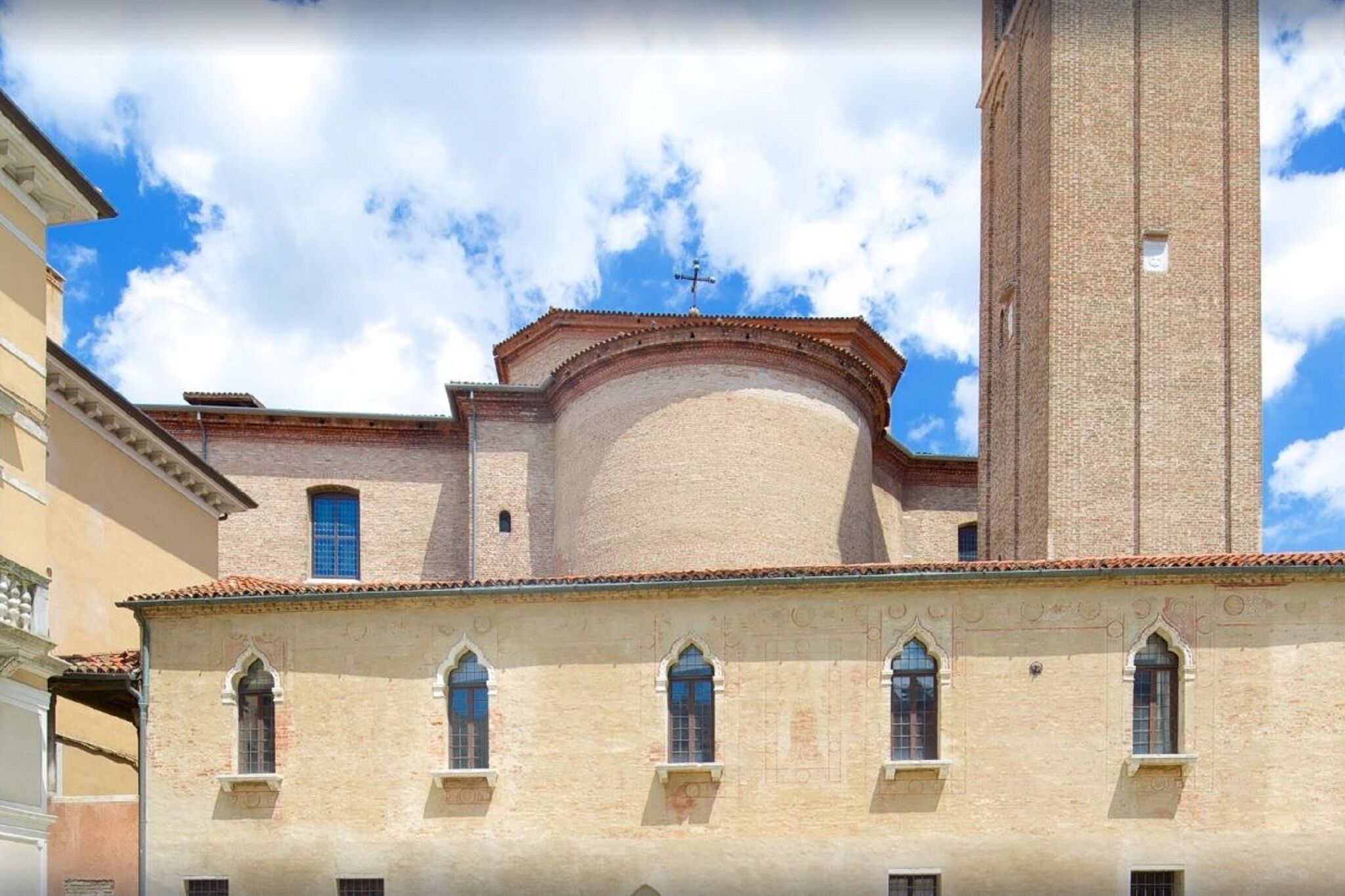 A historic building with a prominent tower and arched windows.
