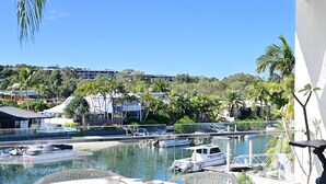 A balcony with a view of a marina, boats, and a pool. - St Tropez 10 - Classic Coastal Water Views (Noosa Heads)
