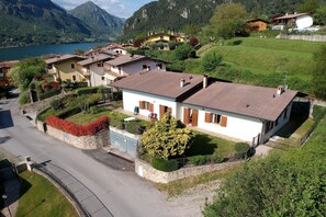 A residential area with houses, a road, and a lake.