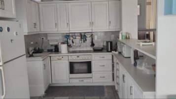 Villa | Private kitchen | Fridge, microwave, oven, stovetop