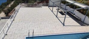 A rooftop pool area with a metal frame structure, surrounded by a metal railing. - Charming 4-bed Villa in Pefkali (Corinth)