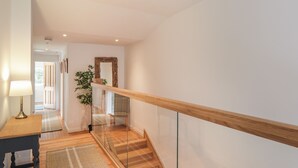 A modern interior with a staircase, wooden flooring, and a glass railing. - Old Manse (Muir of Ord)