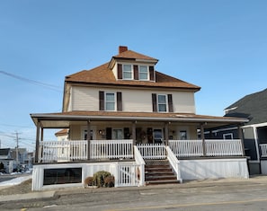Step up to the charming entrance, surrounded by a white picket fence, and enter this two-story house with a cozy porch.