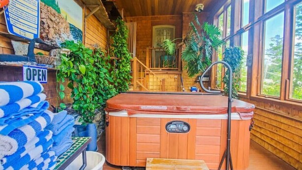 A wooden interior with a hot tub, a staircase, and a view of the outdoors. - 5 Suite in 1820`s house Open Hearth Inn (Trenton)