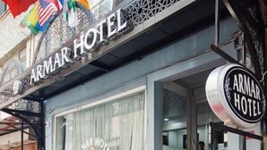 The exterior of the Armar Hotel with a red carpet entrance, a glass facade, and a signboard displaying the hotel name. - Armar Hotel (Istanbul)