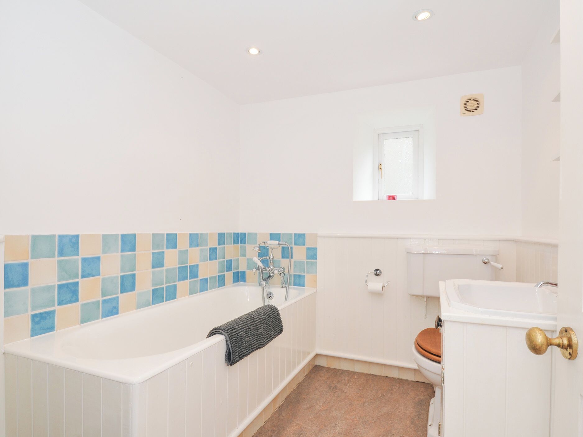 A bathroom with a bathtub, toilet, and sink.