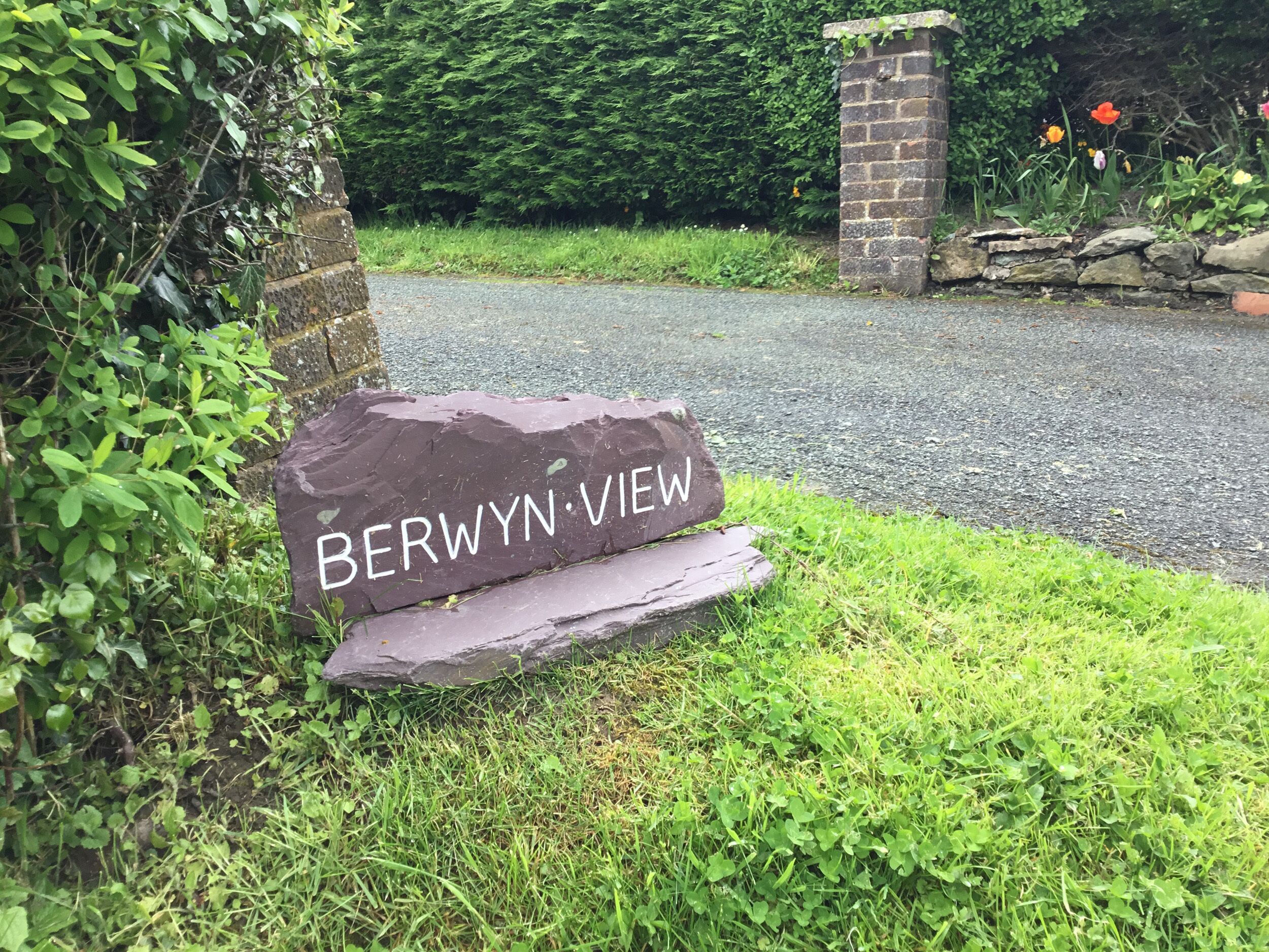 A stone sign with the inscription "BERWYN-VIEW" in a garden setting.