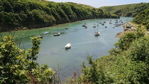 A river with boats and greenery on both sides. - Bwthyn Canol (Haverfordwest)