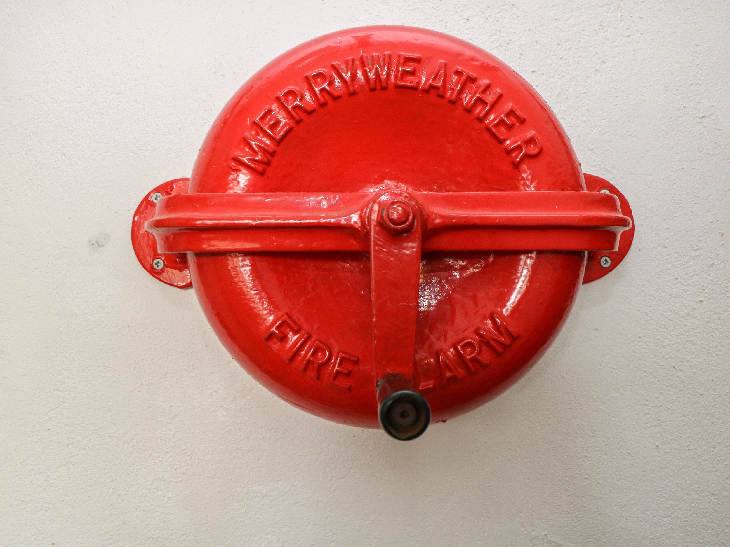 A red fire hydrant with "MERRYWEATHER FIREARM" embossed on it.