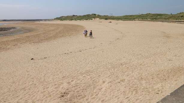 A wide sandy beach with a few people walking. - 2 Chandlers Yard (Burry Port)