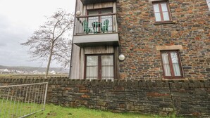 A multi-story building with a stone facade and multiple balconies. - 2 Chandlers Yard (Burry Port)