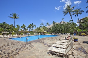 A pool area with lounge chairs and palm trees. - Kamaole Sands #1-105 Renovated Ground Floor Unit, Partial Oceanview, A/C! (Kihei)