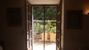 A room with a sliding glass door leading to an outdoor patio area. - Typical Provencal village house with lovely terrace. (Riez)