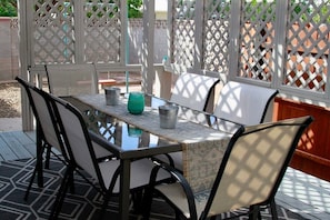 Relax in style on this inviting patio, complete with a glass-top table and comfortable seating for four.